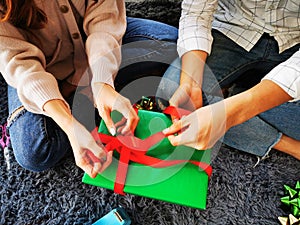 Man and Woman helping giftÃ¢â¬â¹ boxÃ¢â¬â¹ wrapping for Christmas New Year photo